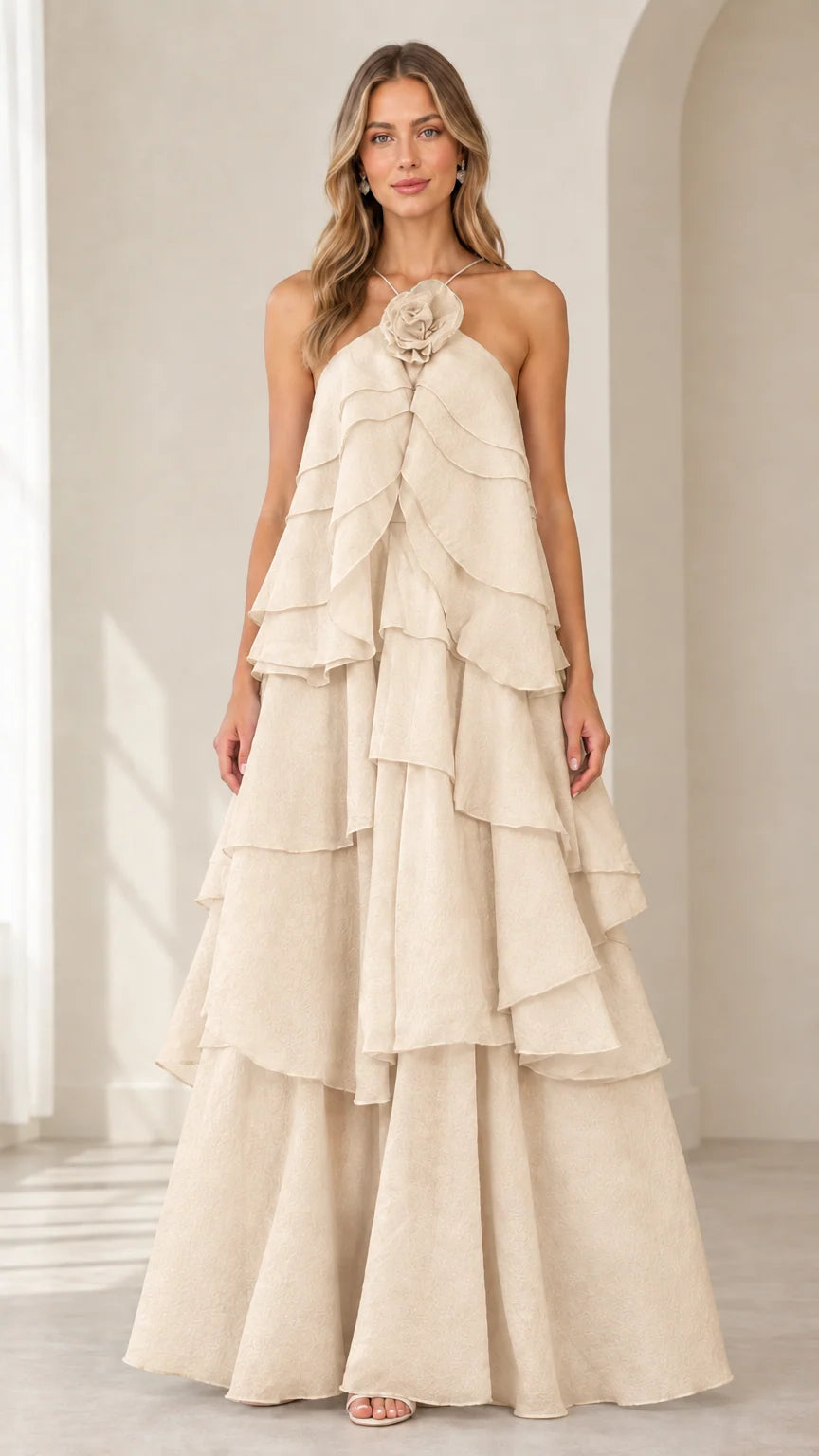 Full-length front view of model wearing Champagne beige tiered rosette maxi gown