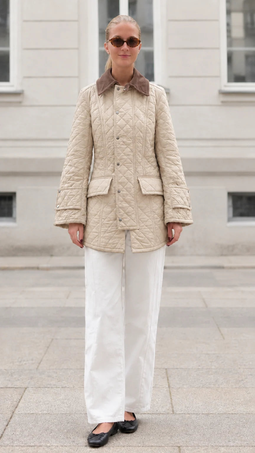 Front full-length view of woman wearing beige diamond quilted barn jacket