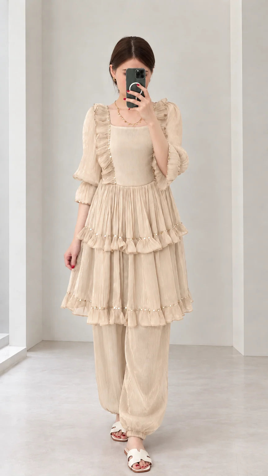 Front view of woman wearing Beige tiered ruffle tunic top and harem pant set