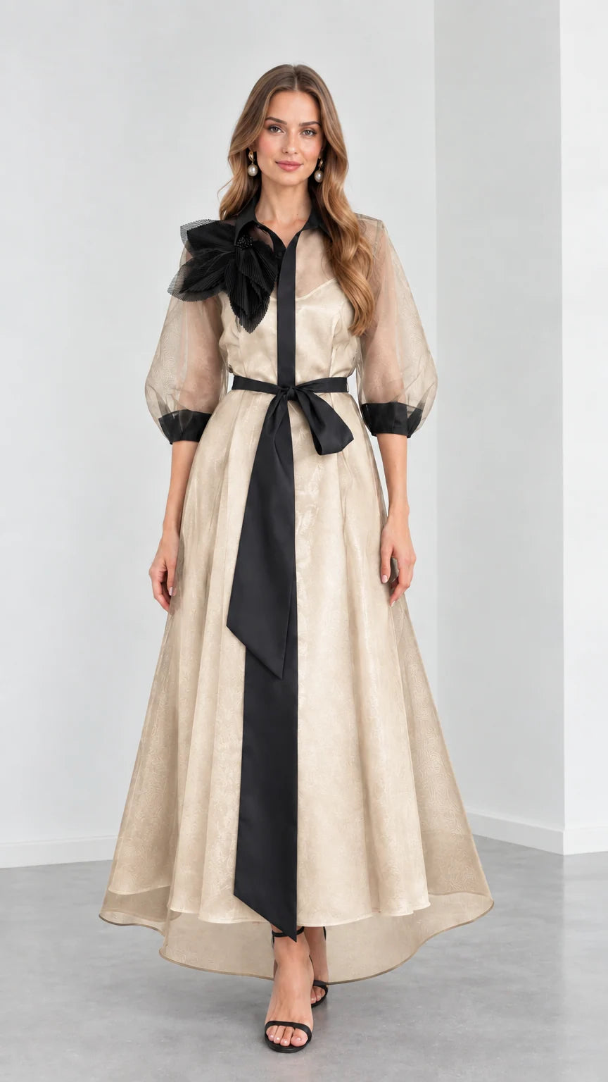 Front view of model wearing Champagne beige organza evening shirt dress with black sash