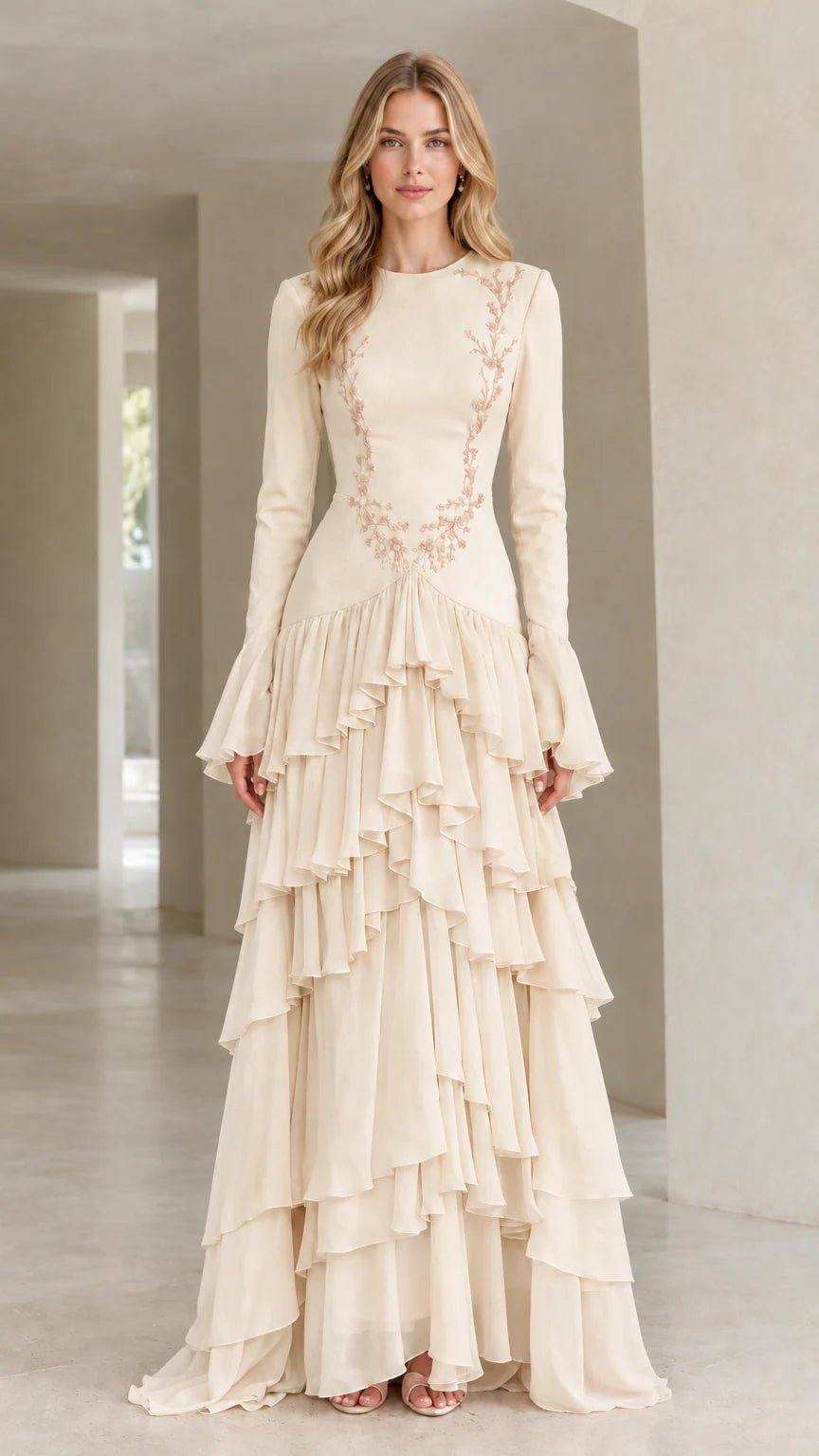 Front full view of woman wearing champagne cream embroidered tiered ruffle long sleeve gown