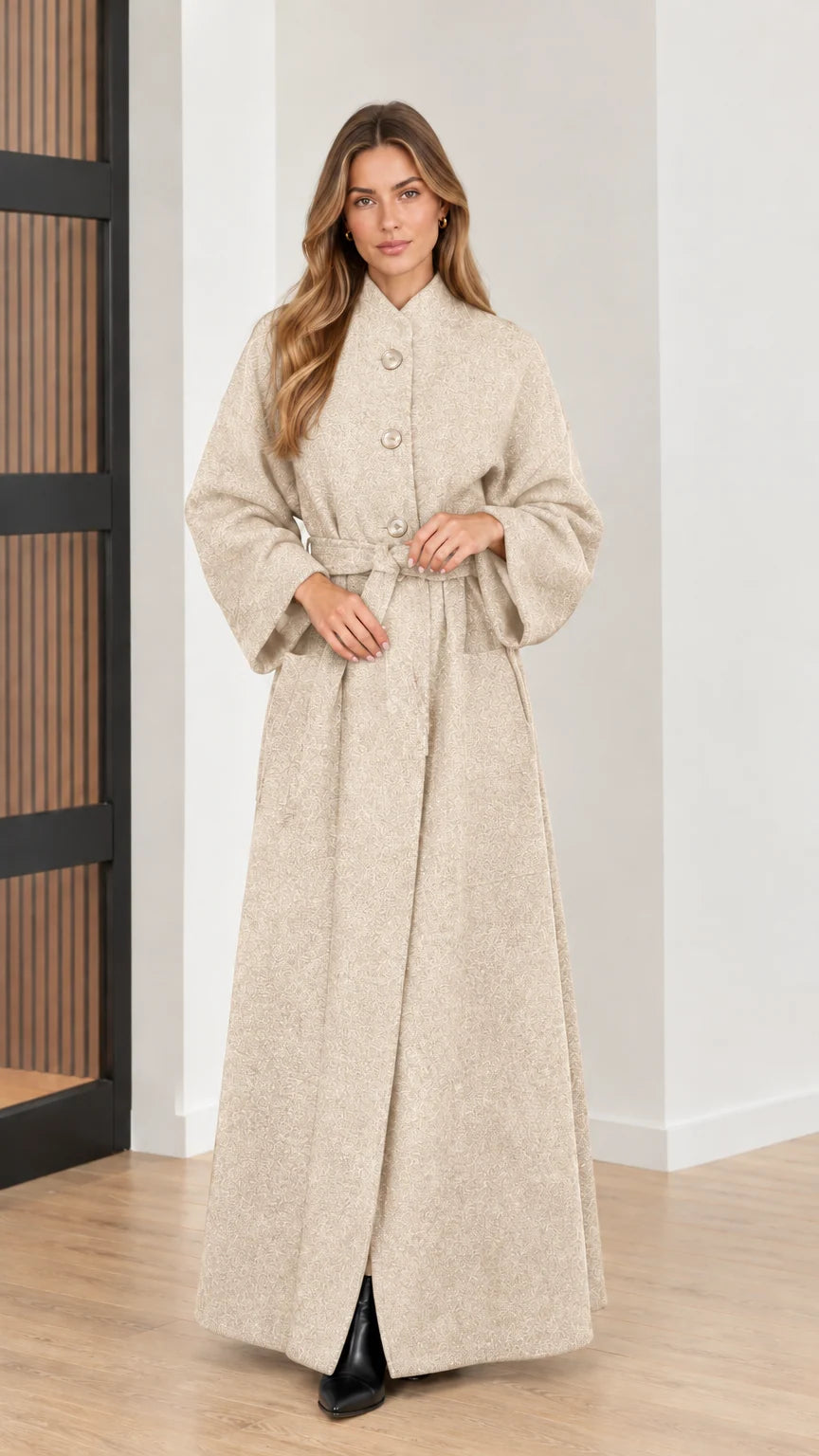 Front view of woman wearing cream beige belted maxi overcoat