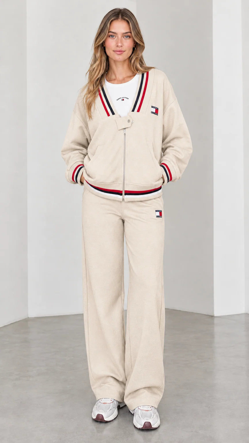 Front view of model wearing beige cream varsity striped tracksuit set